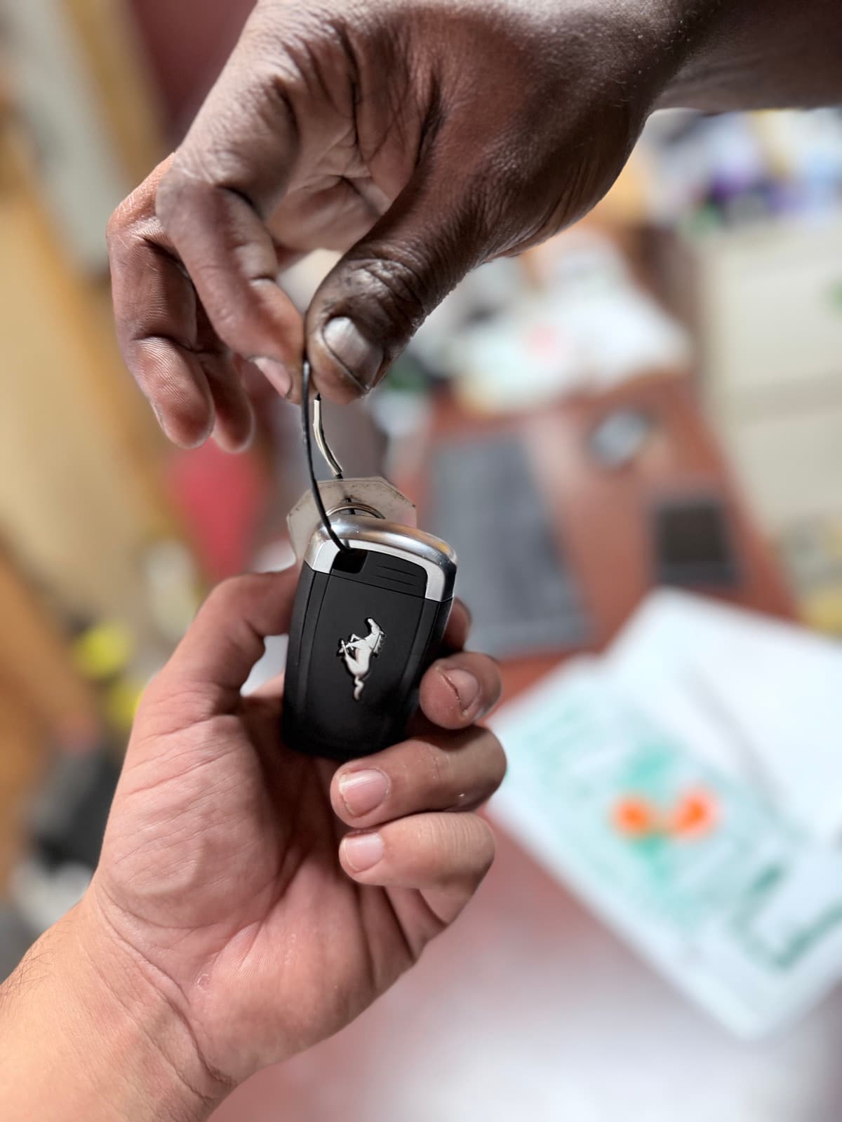 Omari Grant handing car keys to a customer at Fort Lauderdale Auto Sales in Oakland Park