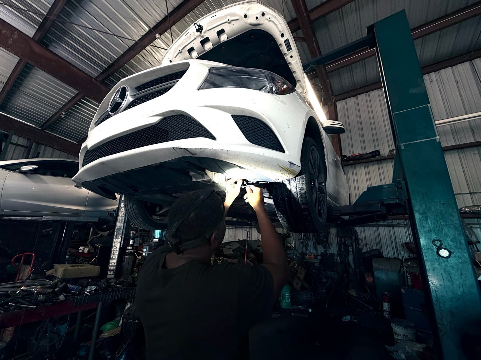 Front Line Auto inspecting a vehicle on a lift in Oakland Park